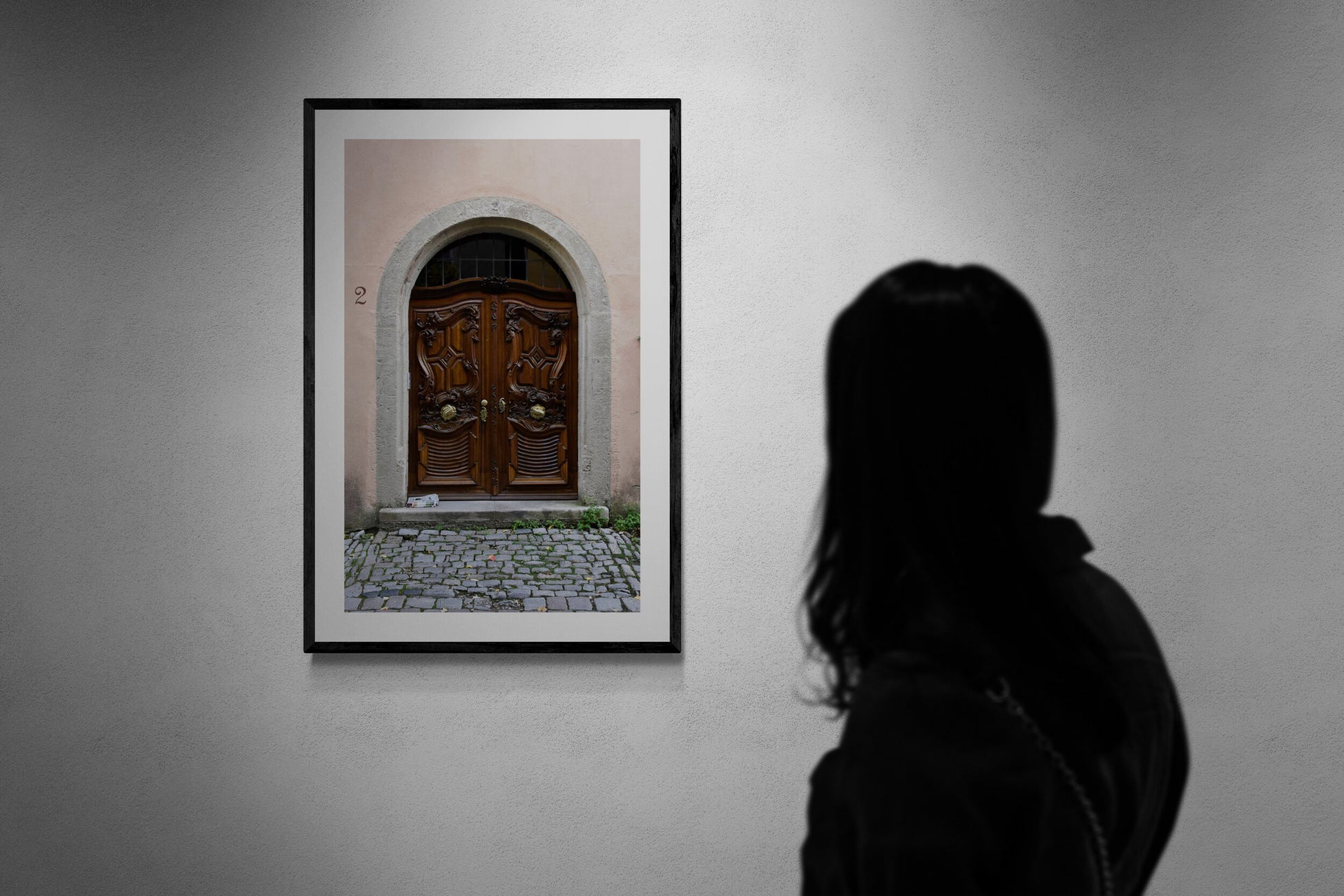 Person looking at a framed photograph of a wooden door on a wall. 2 - Original Photograph by Kim A. Bailey-at-a gallery