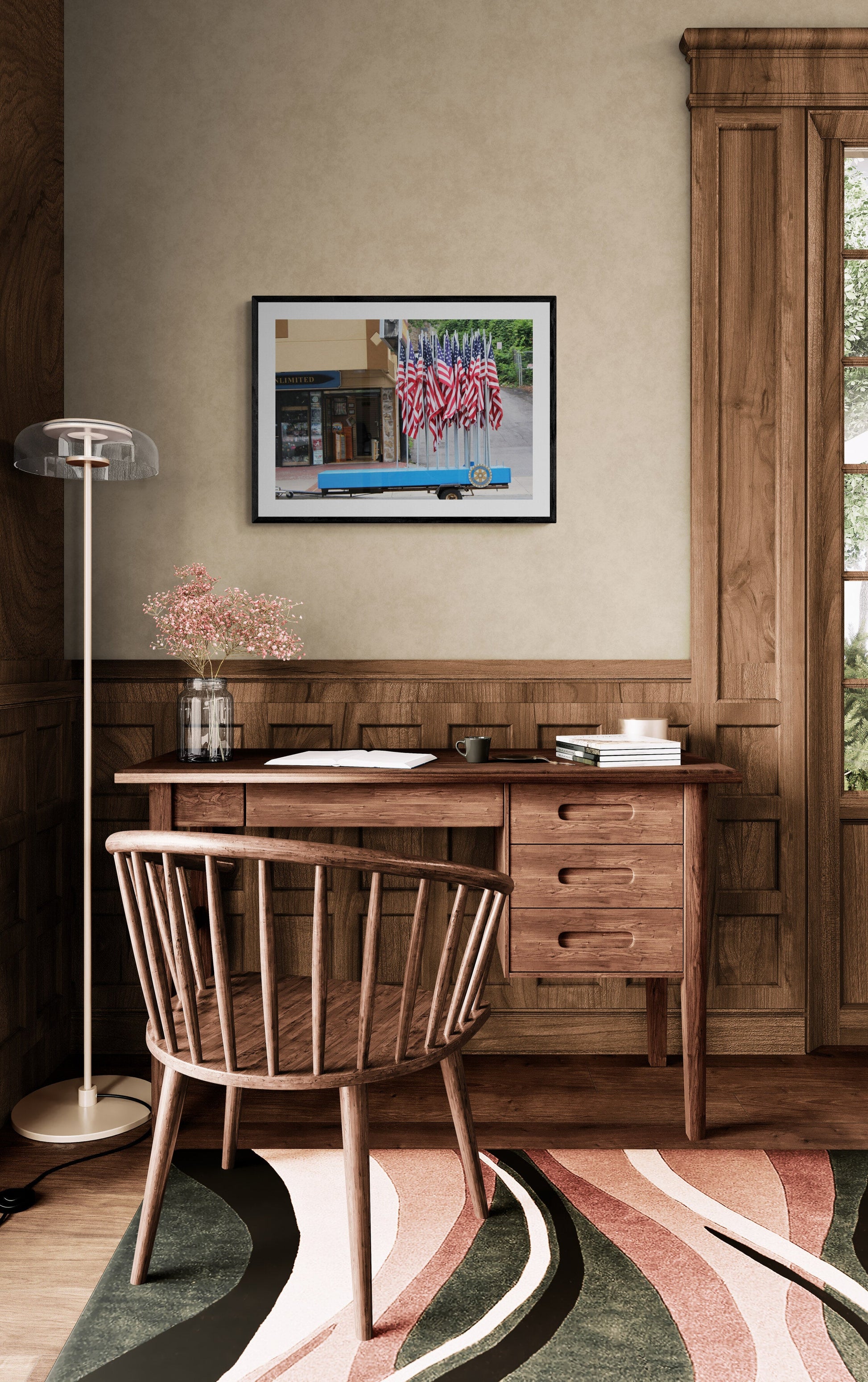 Wooden desk with chair in a room with a painting on the wall.