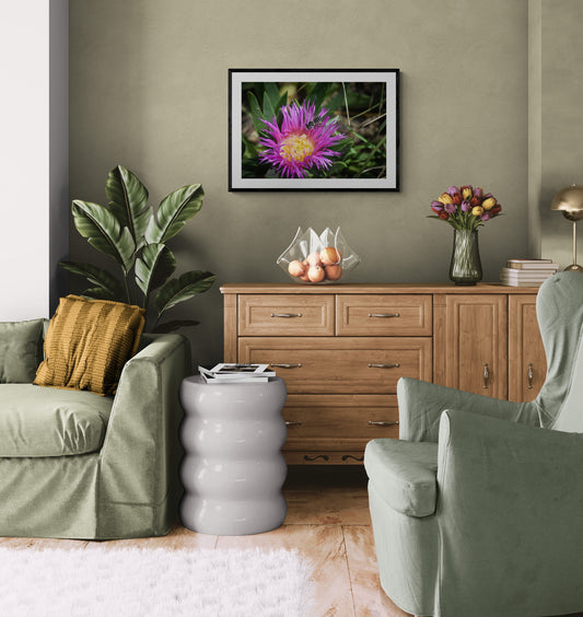 Living room with green sofa, wooden sideboard, and decorative items.