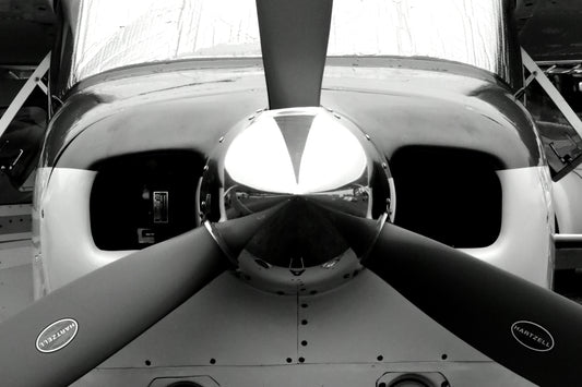 Black and white abstract photograph of an airplane propeller emphasizing geometric patterns and the play of light and shadow. Black and White Propeller, Original Photograph by Kim A. Bailey