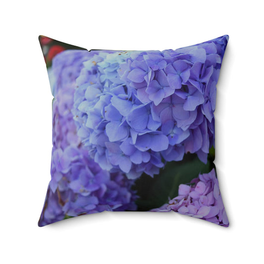 Decorative pillow with a purple flower pattern on a white background