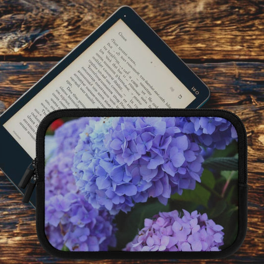 Tablet with a purple flower case on a wooden surface