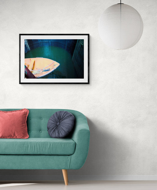 Framed photograph on a wall above a teal sofa with pink and purple cushions. Boat in a Lock - Portugal, Original Photograph by Kim A. Bailey