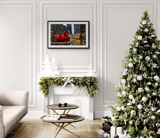 Living room with Christmas tree, fireplace, and artwork on a white wall.