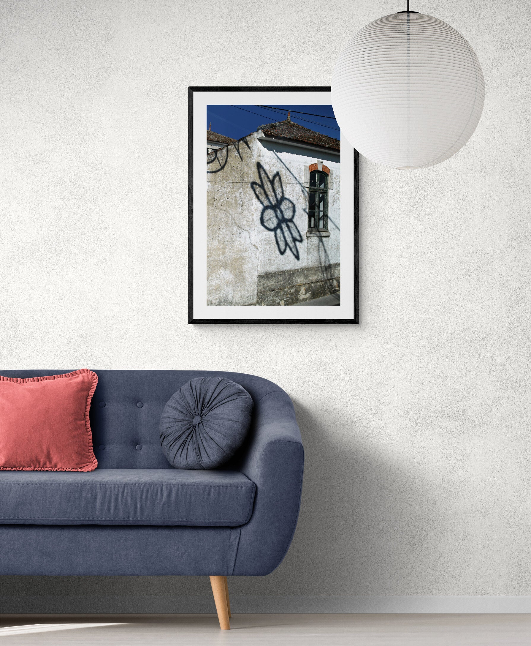 Framed artwork above a blue sofa with pink cushions in a living room. Flower Shadow - Portugal, Original Photograph by Kim A. Bailey