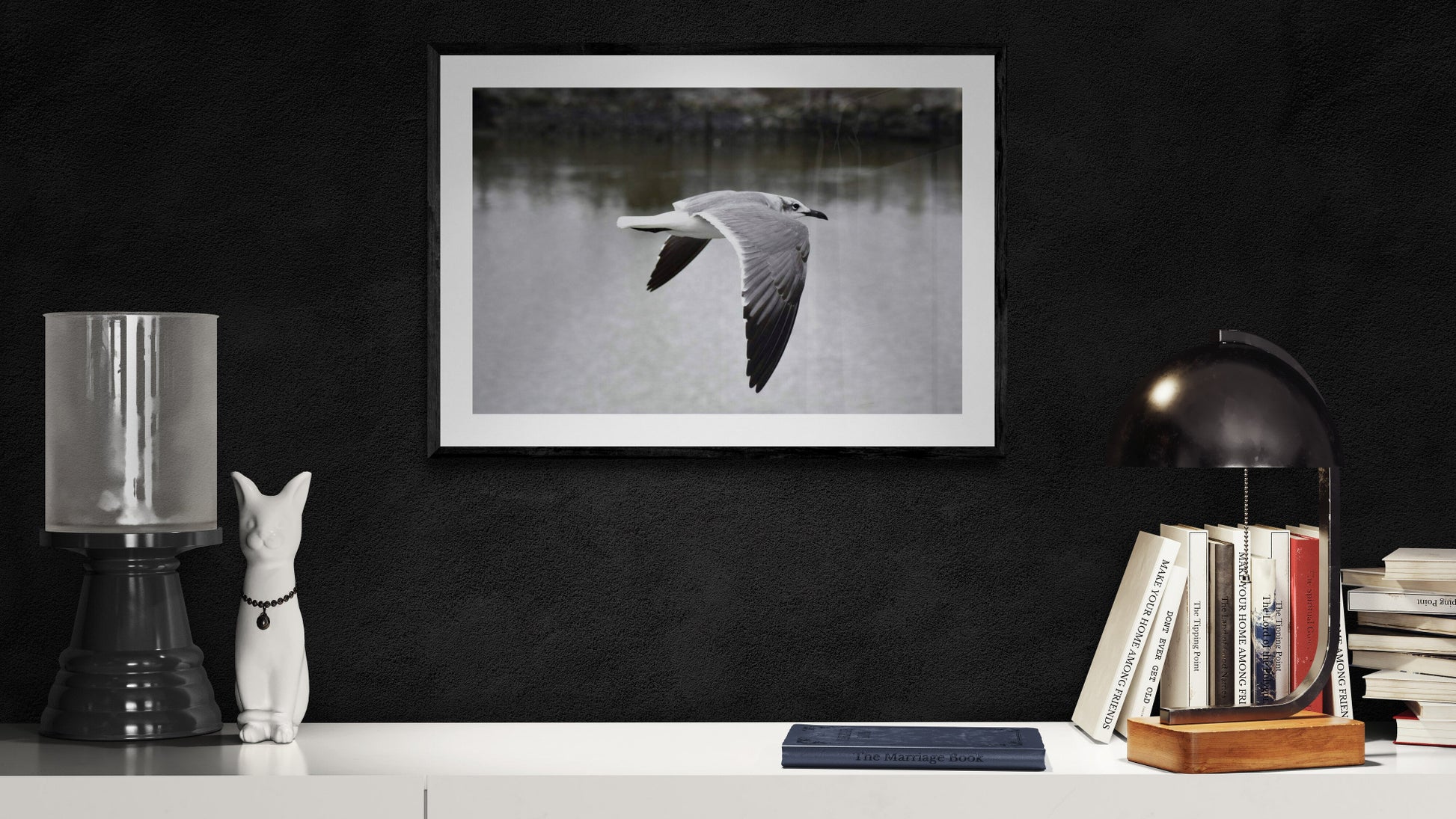 Framed black and white photo of a bird over water on a dark wall with decorative items. Flying Seagull, Original Photograph by Kim A. Bailey