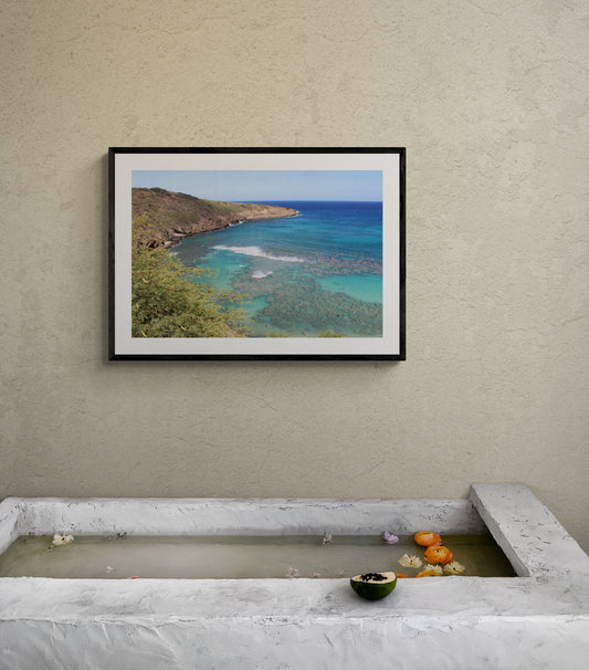 Framed photograph of a coastal landscape above a stone basin with fruit. Hanauma Bay Surf Original Photograph by Kim A. Bailey