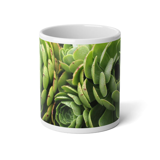 A white ceramic mug with a green succulent plant design.