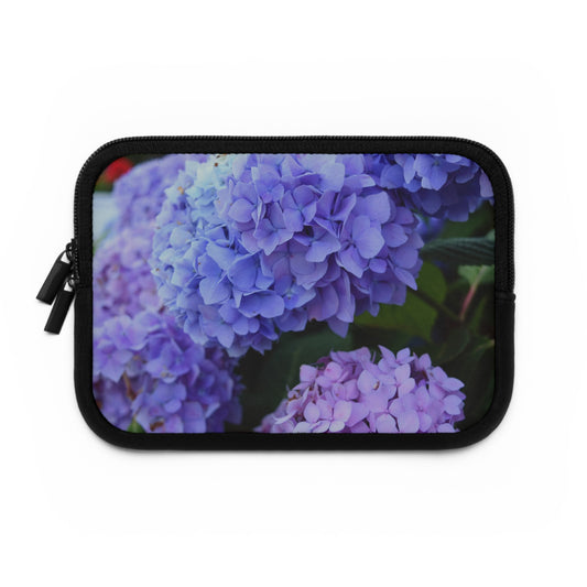 A black neoprene laptop or tablet sleeve featuring a purple hydrangea flower design.