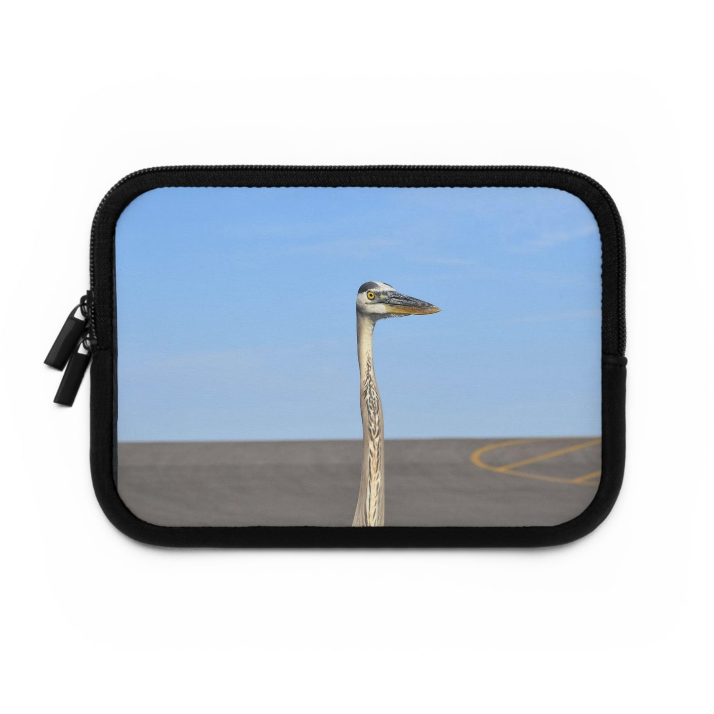 A laptop or tablet sleeve with a photograph of a heron against a blue sky and a sandy background.