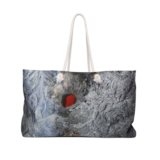 A large tote bag with a geometric pattern featuring a Lava Tube Weekender Tote Bag heart, with cream rope handles.