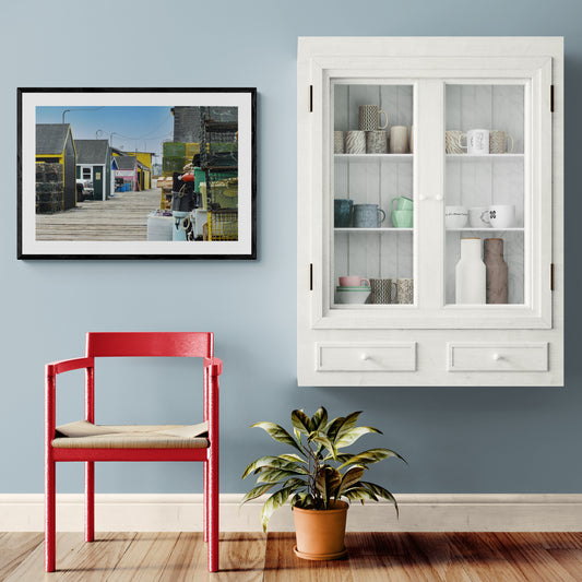 Red chair, potted plant, and white cabinet against a light blue wall. Maine Lobster Original Photograph by Kim A. Bailey