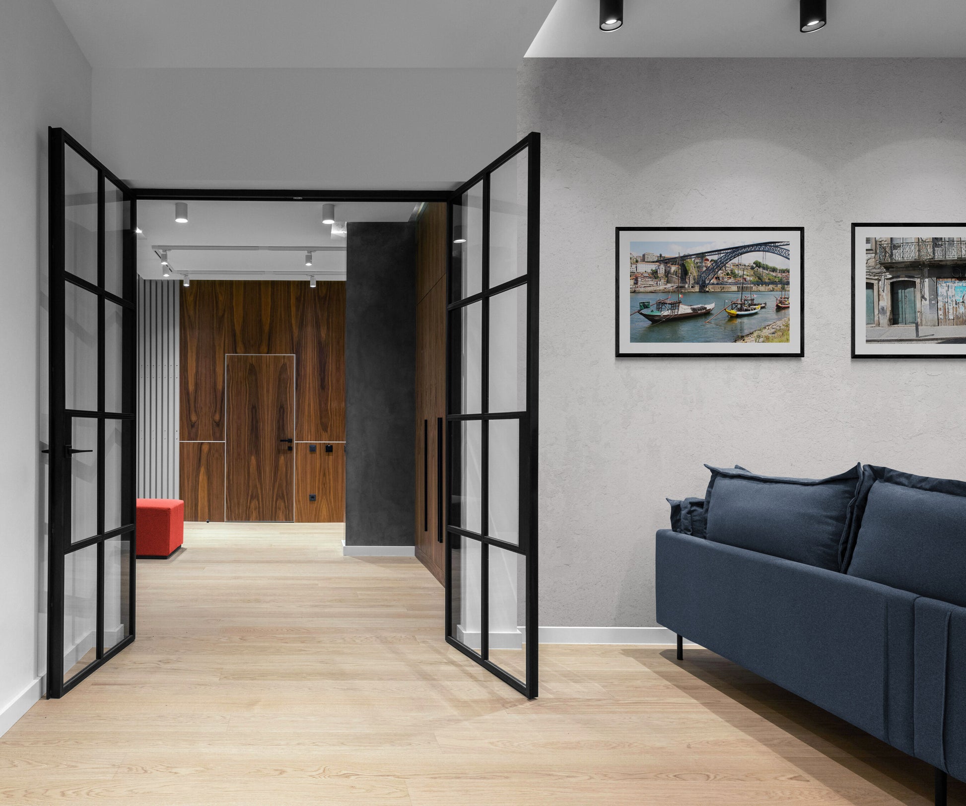 Modern living room with open, black-framed doors and a blue sofa. Maria Pia Bridge, Porto Original Photograph by Kim A. Bailey