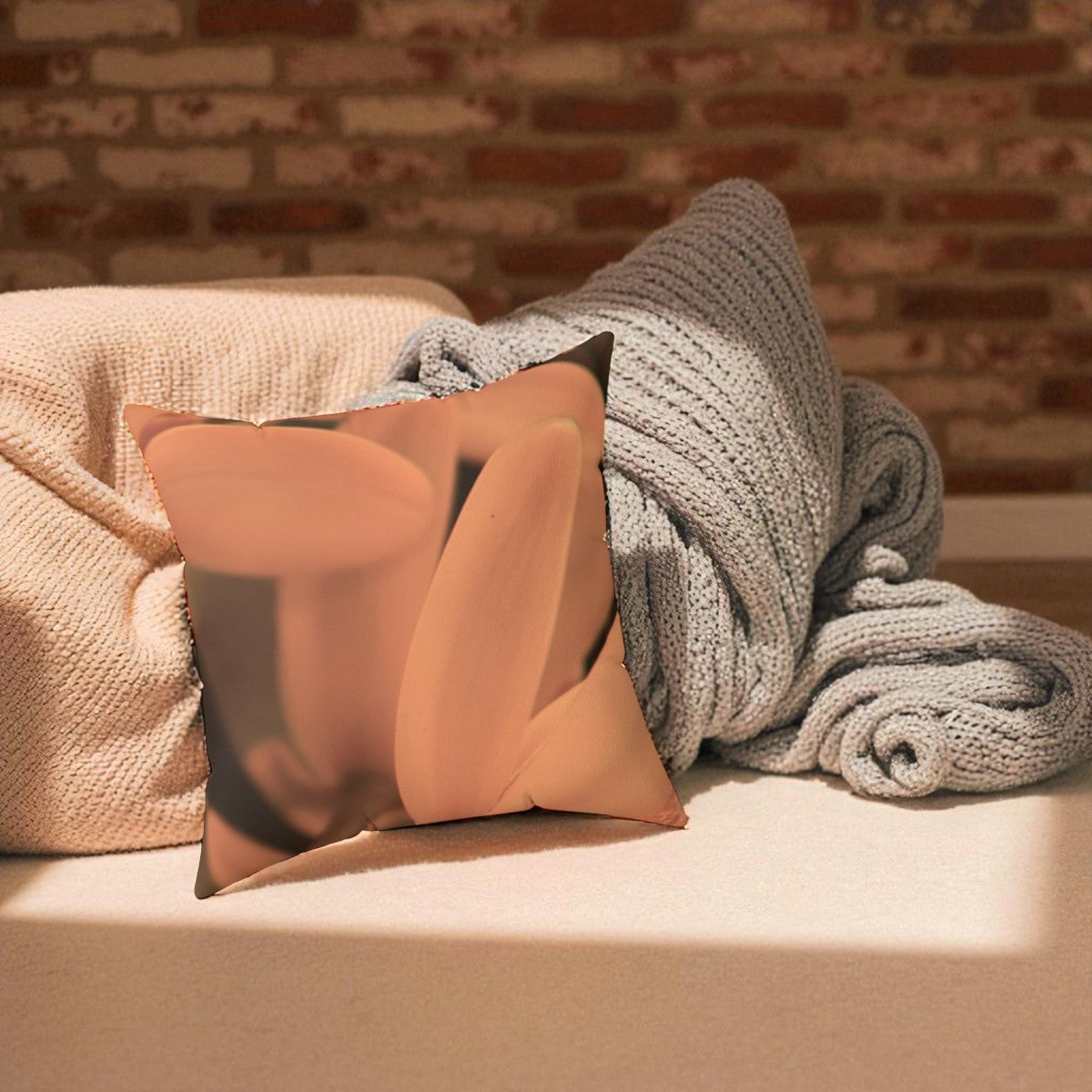 Two pillows and a blanket on a surface with a brick wall background