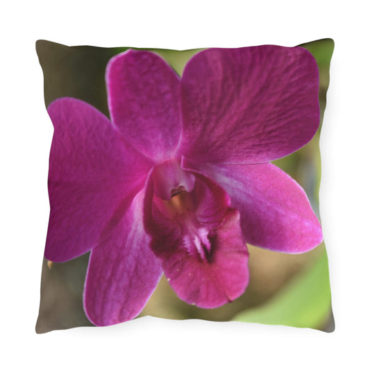Pillow with a pink orchid design on a white background