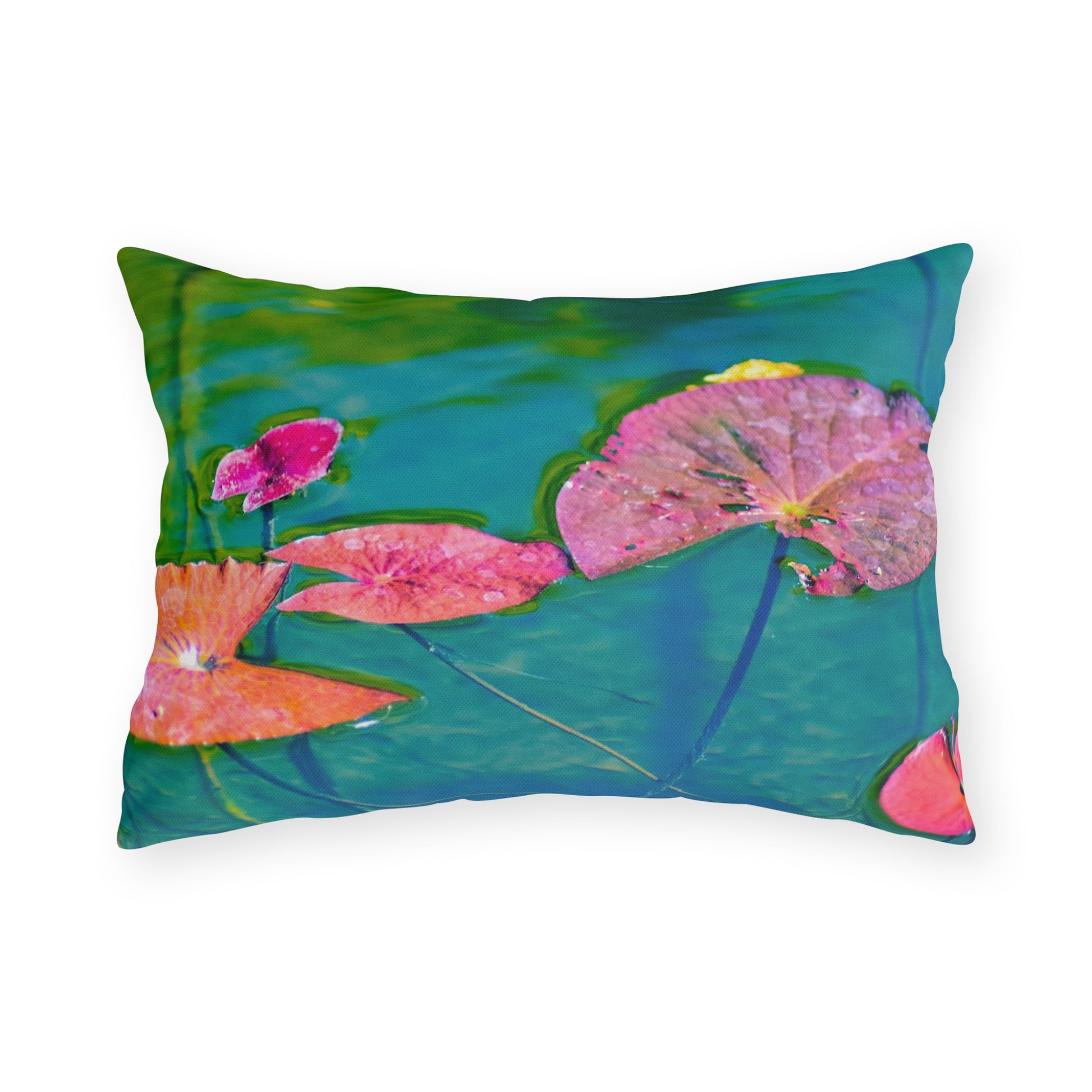 A square outdoor pillow with a photograph of pink and green water lily leaves on a pond.