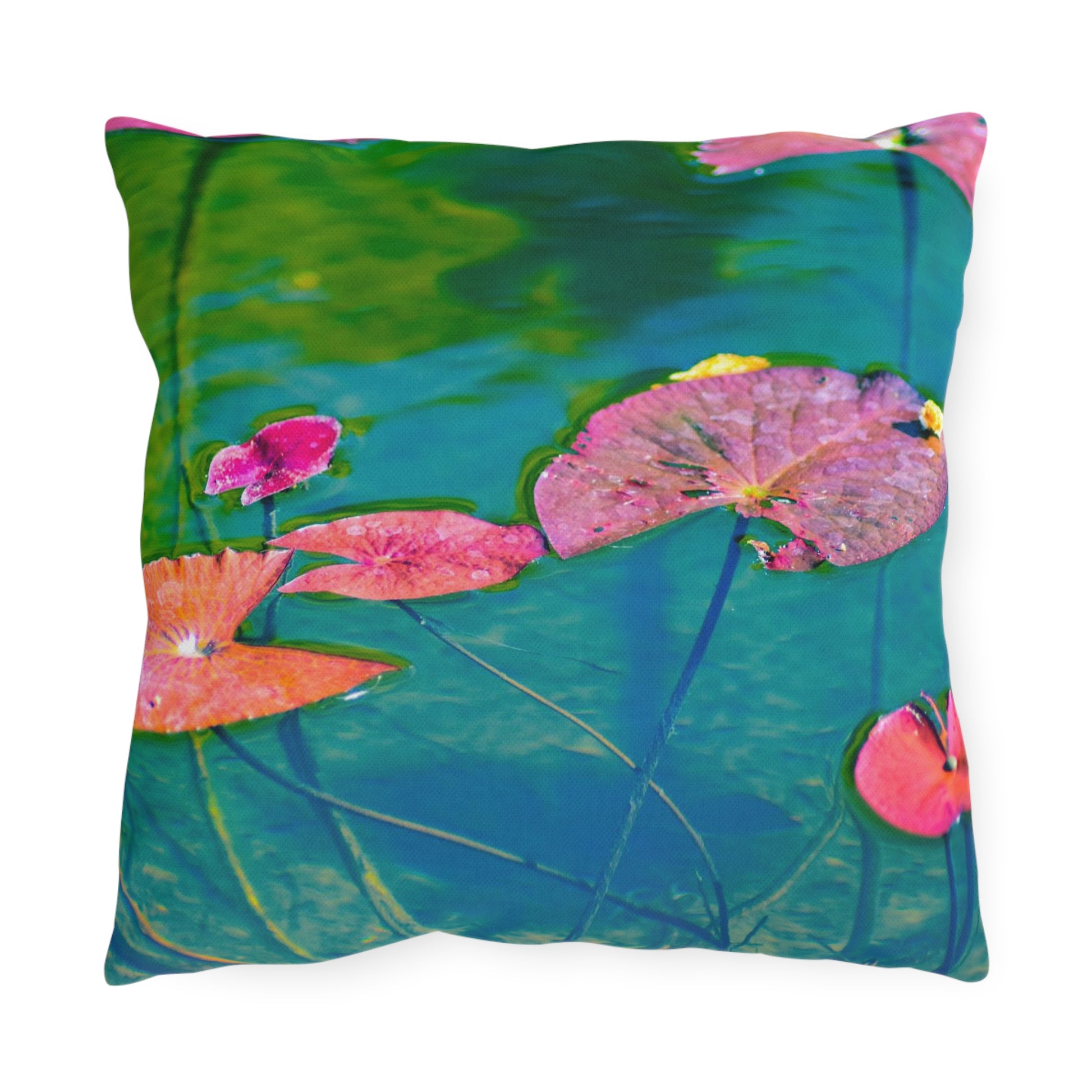 A square outdoor pillow with a photograph of pink and green water lily leaves on a pond.