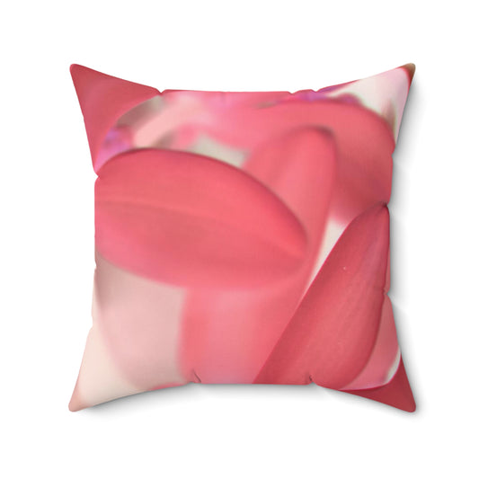 Decorative pillow with pink floral pattern on a white background