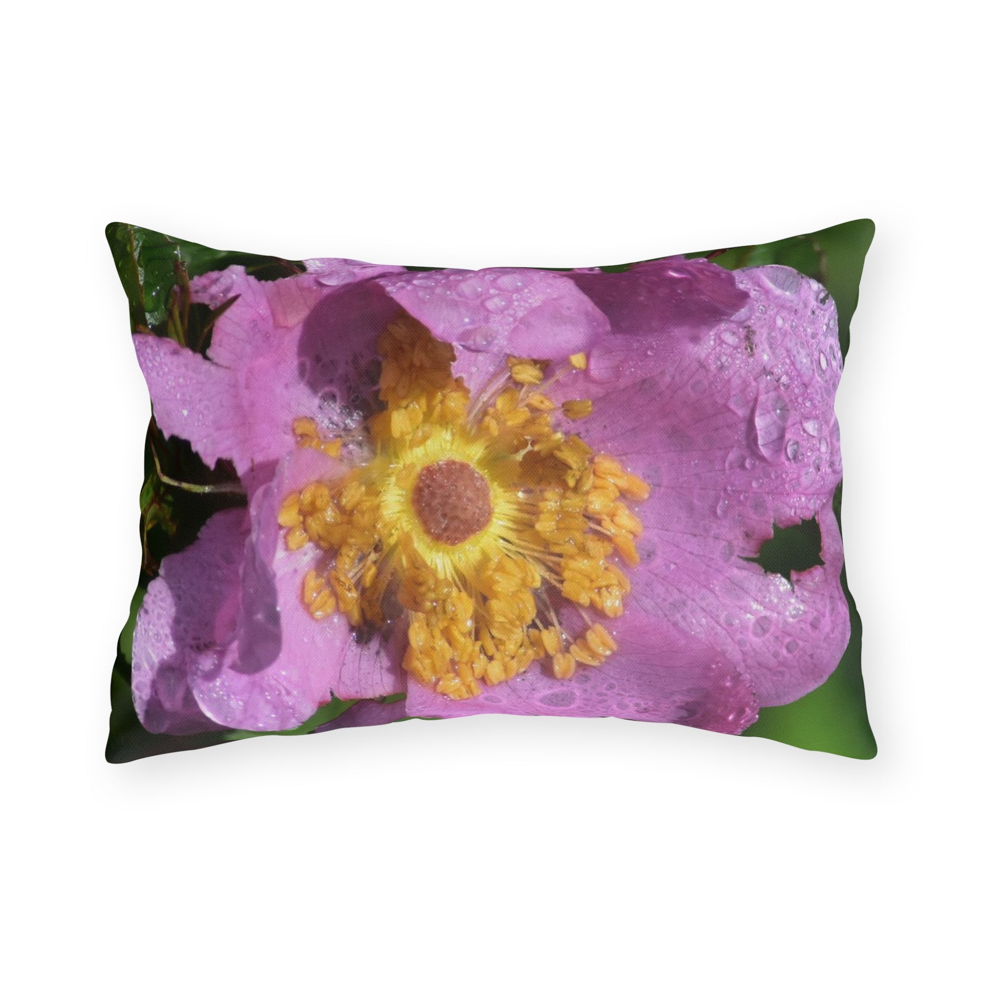 Decorative pillow with a pink flower and yellow center design on a white background