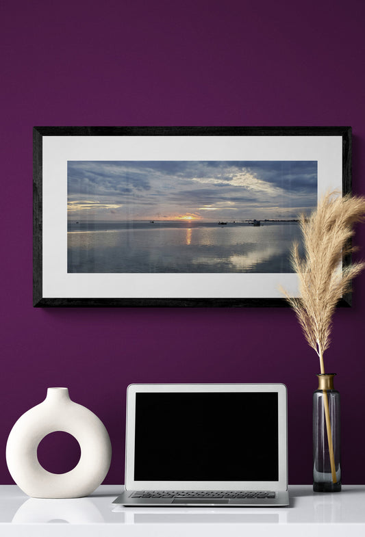 Framed landscape picture, laptop, and vases on a purple wall. Sunset at Ft. Myers Beach, Original Photograph by Kim A. Bailey