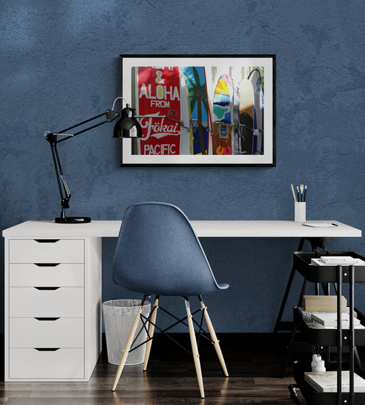 Modern office setup with a desk, chair, and artwork on a blue wall. Surfboards in Honolulu, Hawaii, Original Photograph by Kim A. Bailey