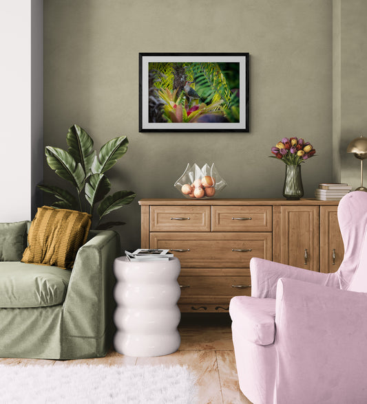 Living room with green and pink chairs, wooden cabinet, and plant.