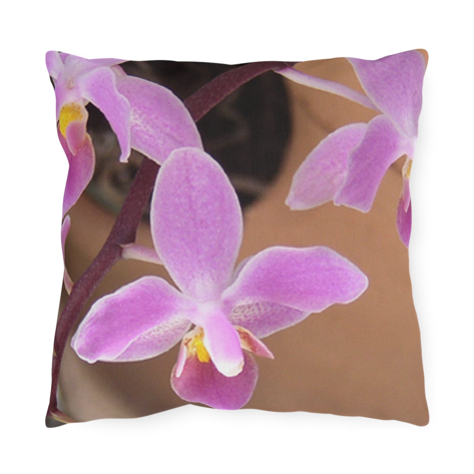 Pillow with pink orchid design on a white background