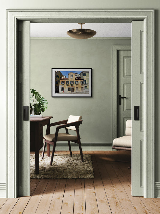View of a room with a chair, table, and plant through a open door. Venice Residence, Original Photograph by Kim A. Bailey