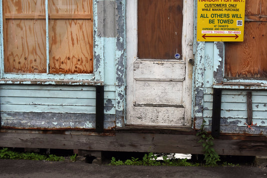 A color photograph of a weathered lobster store on a dock, with signs of aging and use, including a yellow sign that reads 'CUSTOMERS ONLY', and a door with visible wood grain and paint wear. Weathered Lobster Store Original Photograph by Kim A. Bailey