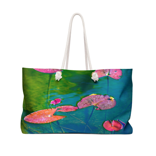 Tote bag with pink lily pads on a green background