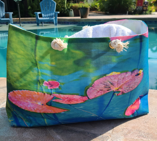 Colorful tote bag with water lily design by a pool