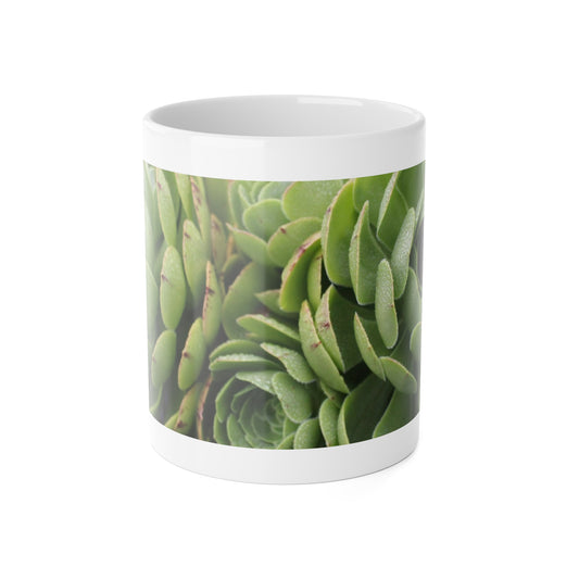 A white ceramic mug with a glossy finish, featuring a green succulent plant design.