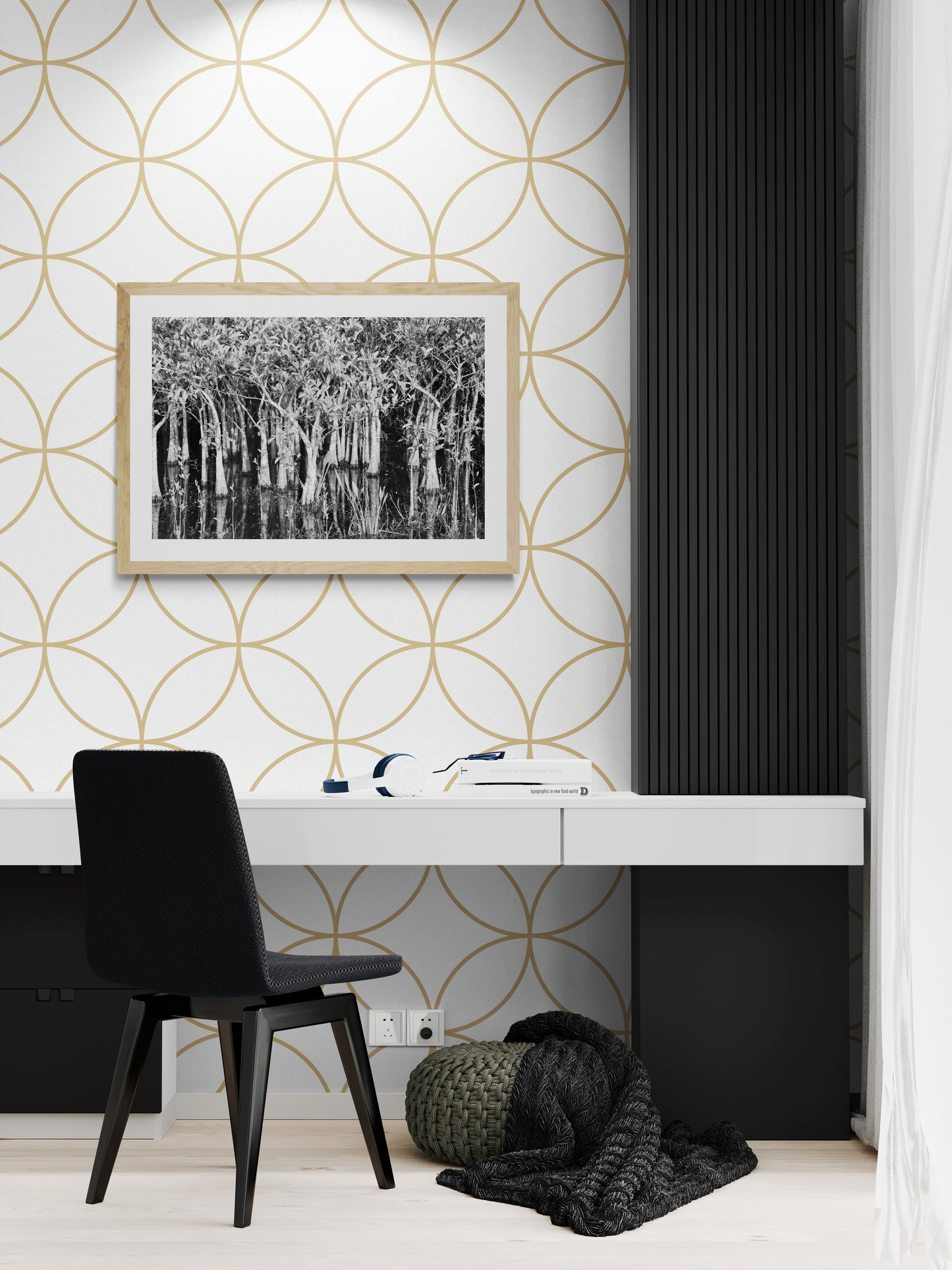 Modern office space with geometric patterned wallpaper and black chair.