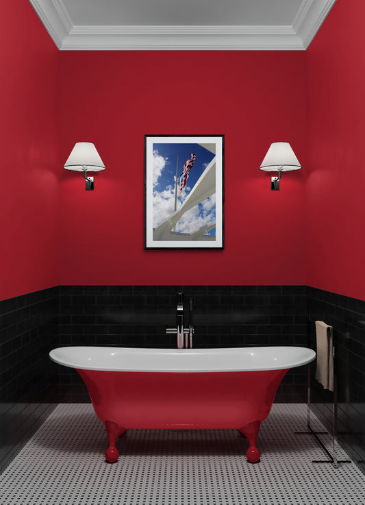 Bathroom with red walls, black border, and white bathtub.