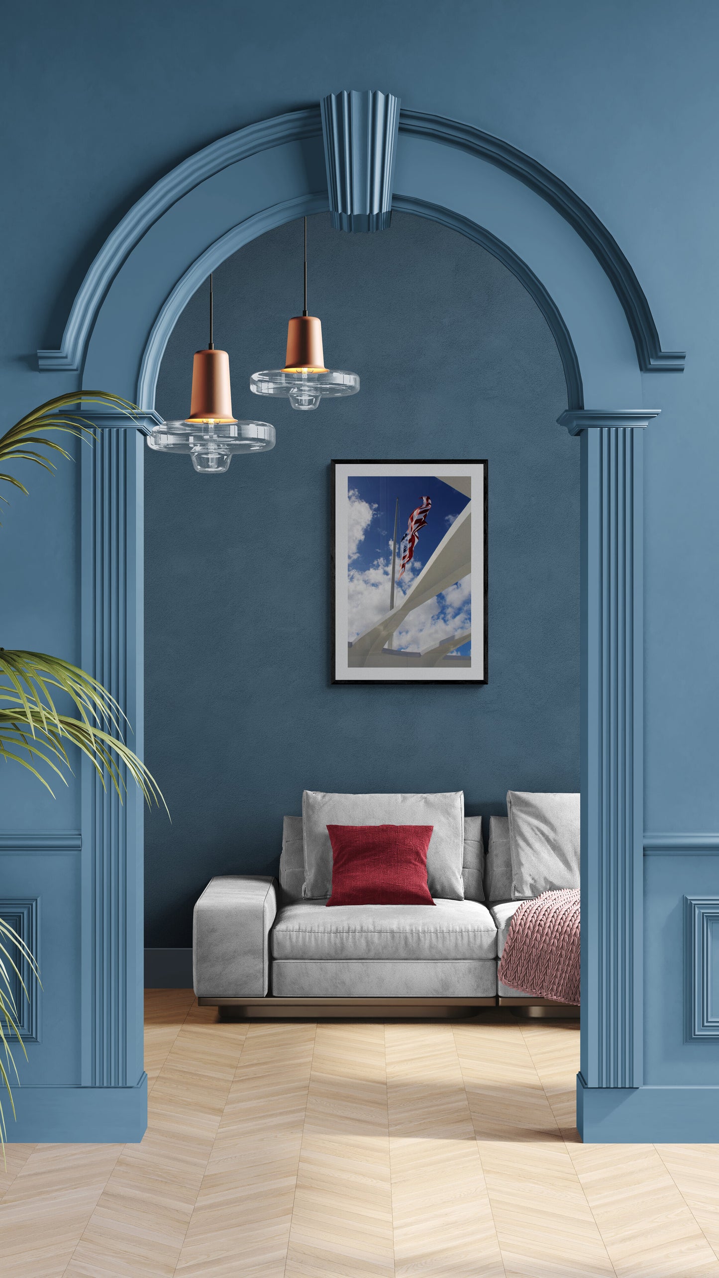 Modern living room with blue walls, a gray sofa, and a framed picture.