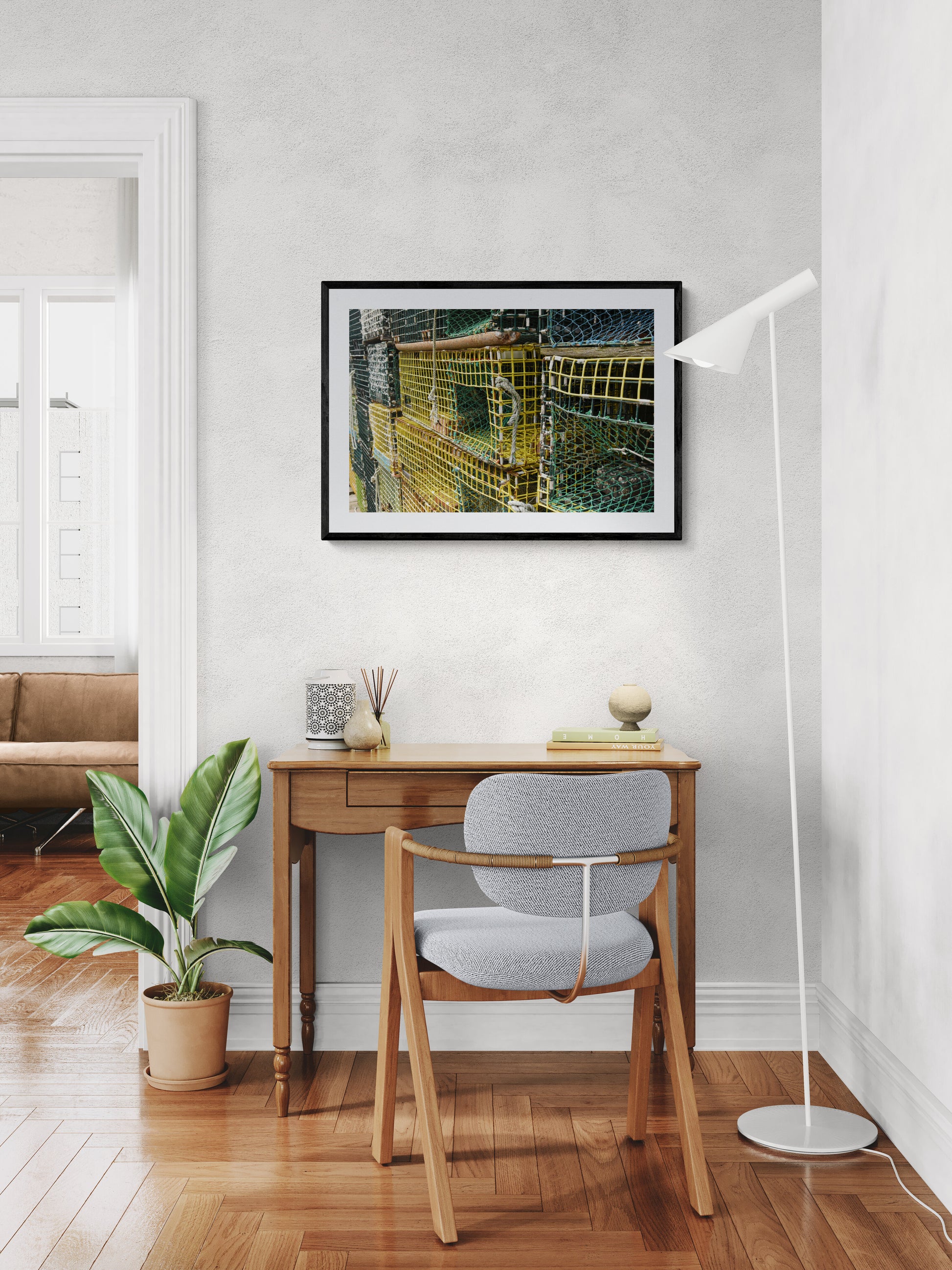 Modern home office with desk, chair, and artwork.