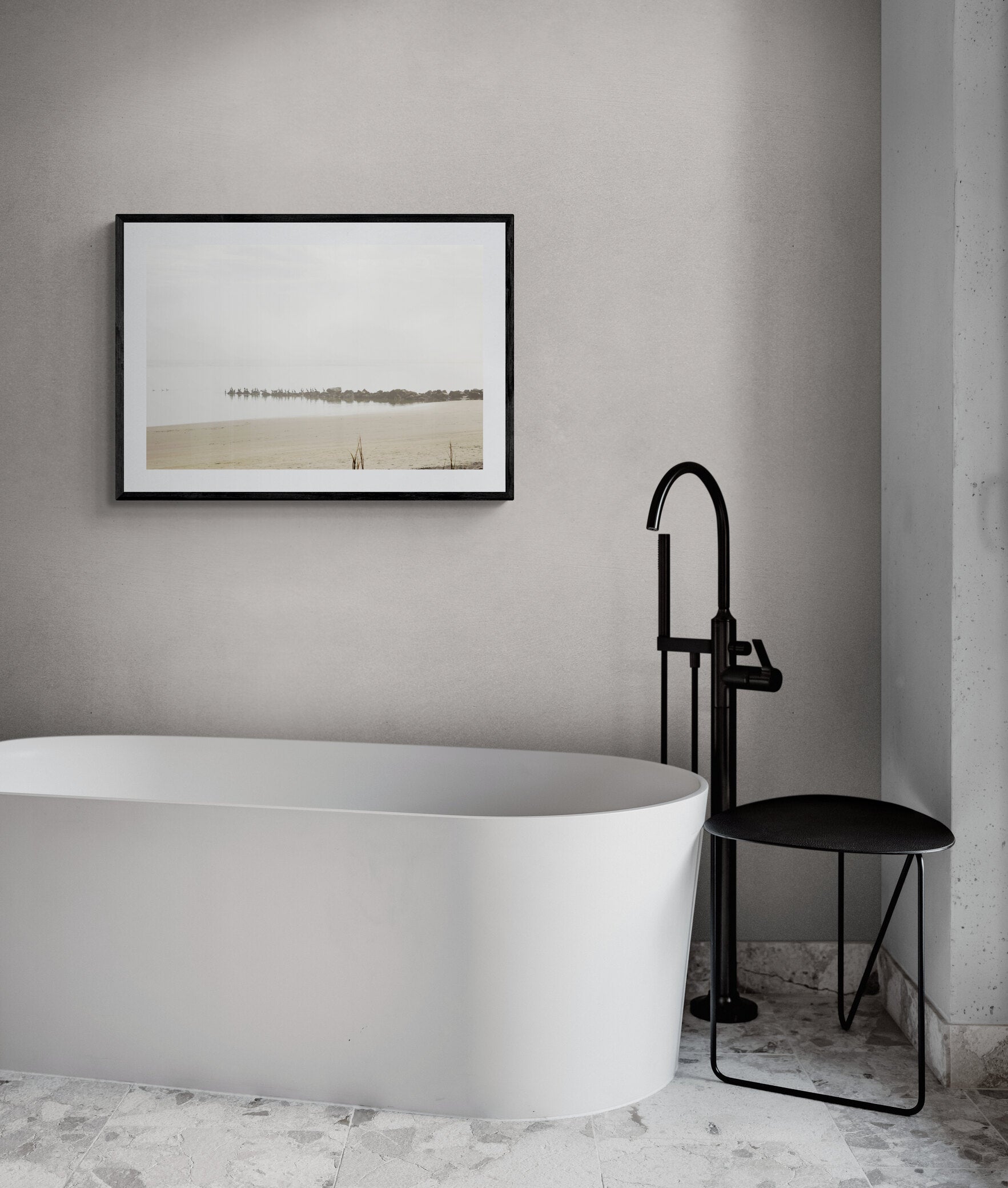 Minimalist bathroom with white bathtub and black fixtures.