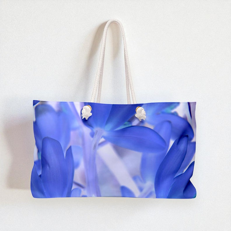 Tote bag with blue floral design on a white background