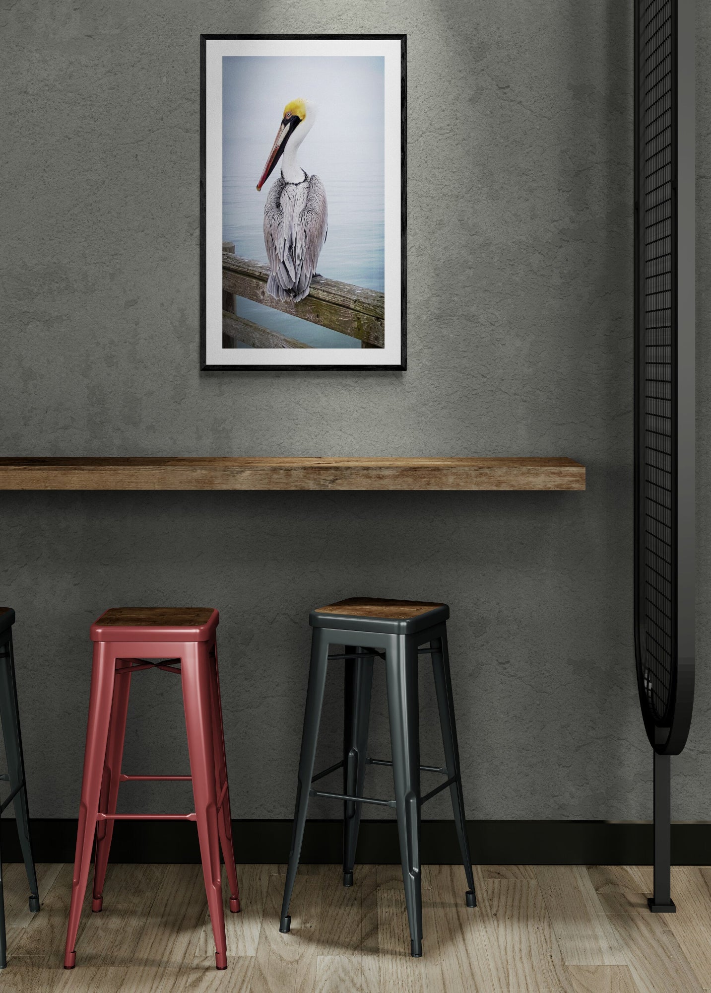 Framed picture of a pelican on a wall above two stools. Brown Pelican with Yellow Head, Original Photograph by Kim A. Bailey