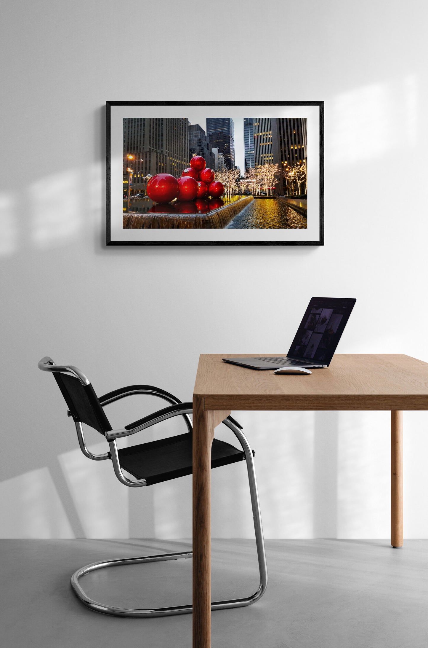 Modern office setup with a framed artwork on the wall, desk, and chair.