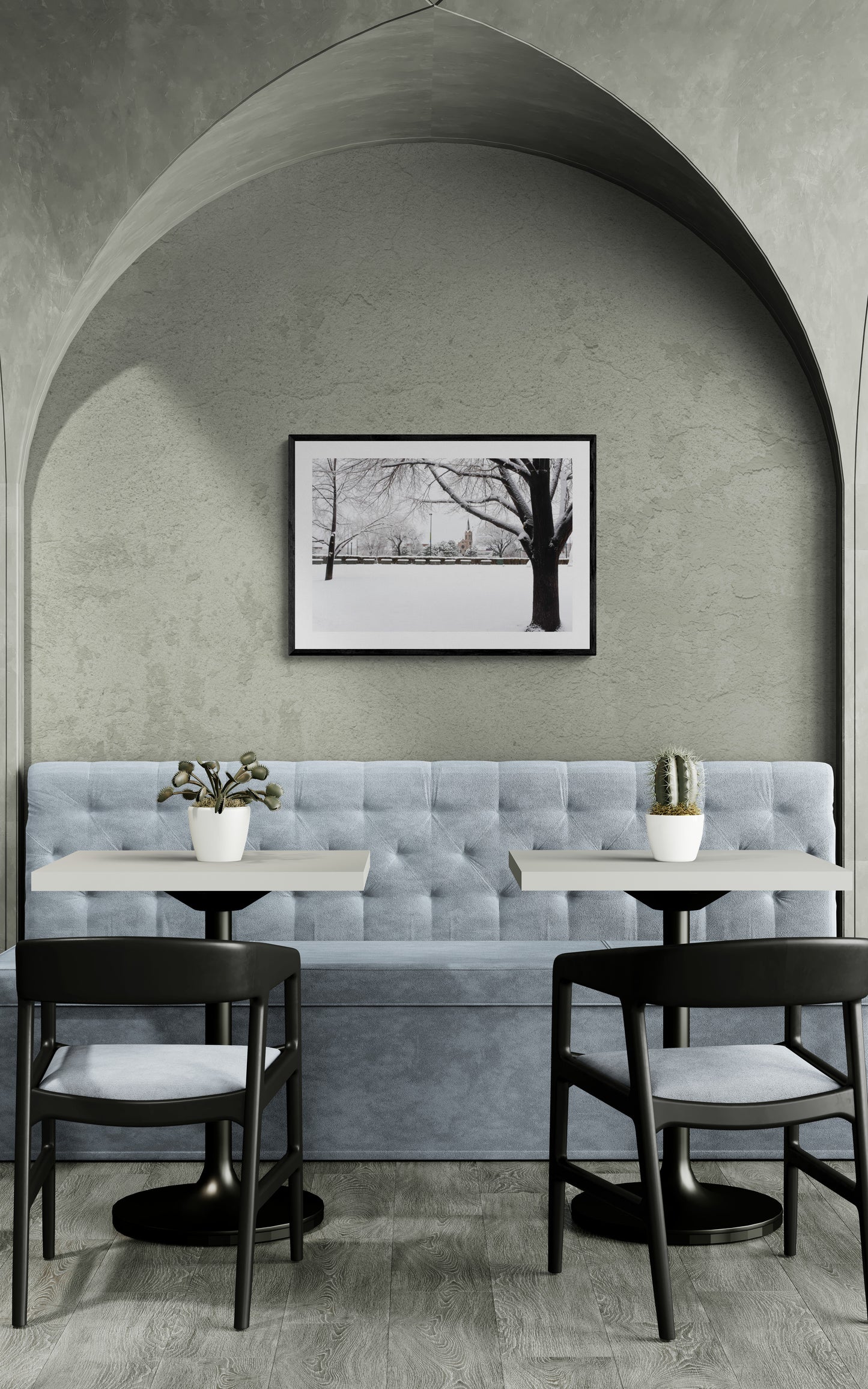 Modern interior with gray walls, a tufted bench, and black chairs.