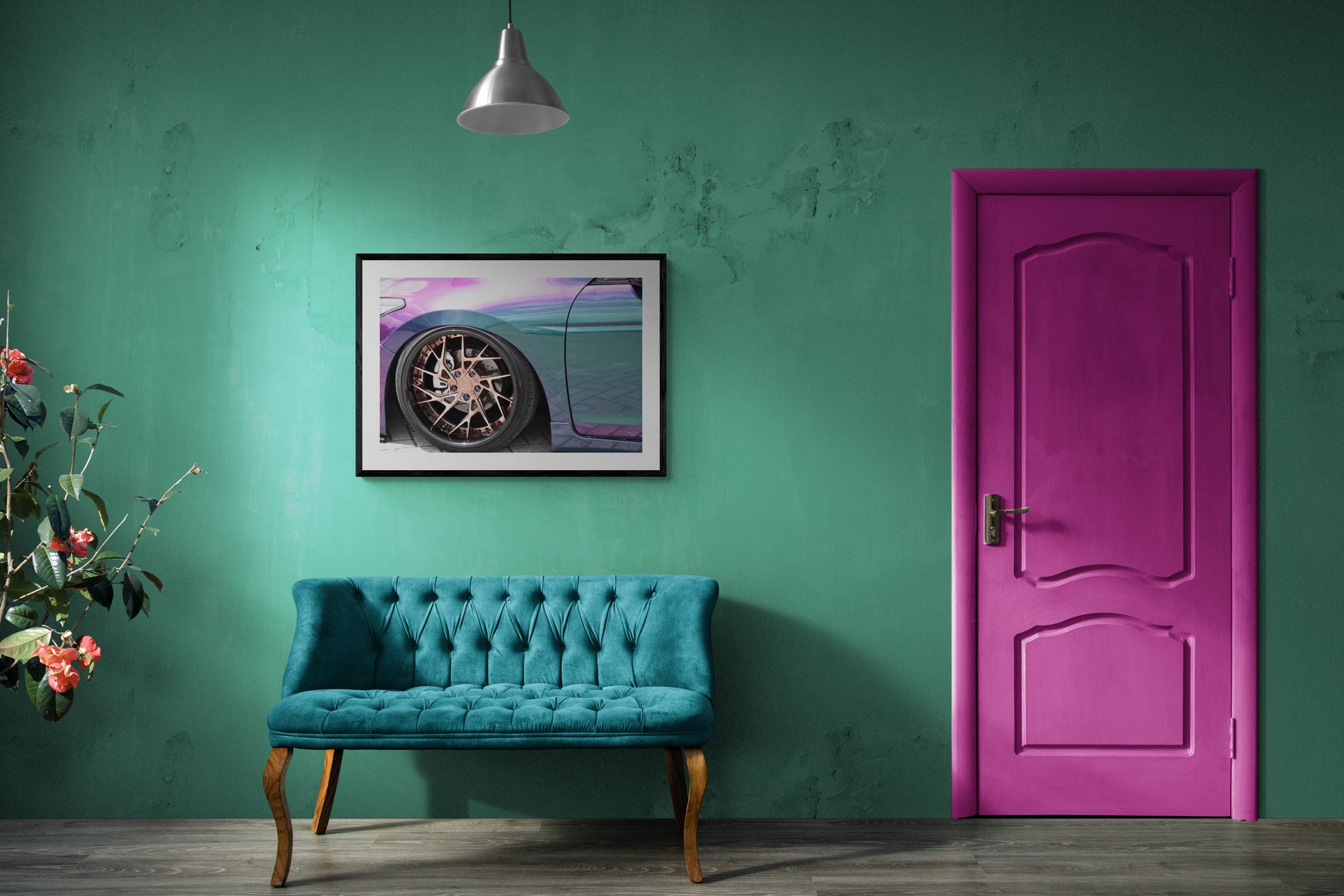 Turquoise sofa against a green wall with a pink door and framed picture of a car.