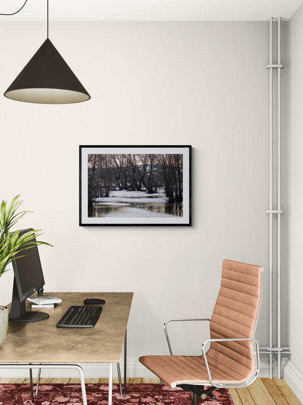 Modern office desk with chair and decor against a white wall. End of Winter, Melting Snow