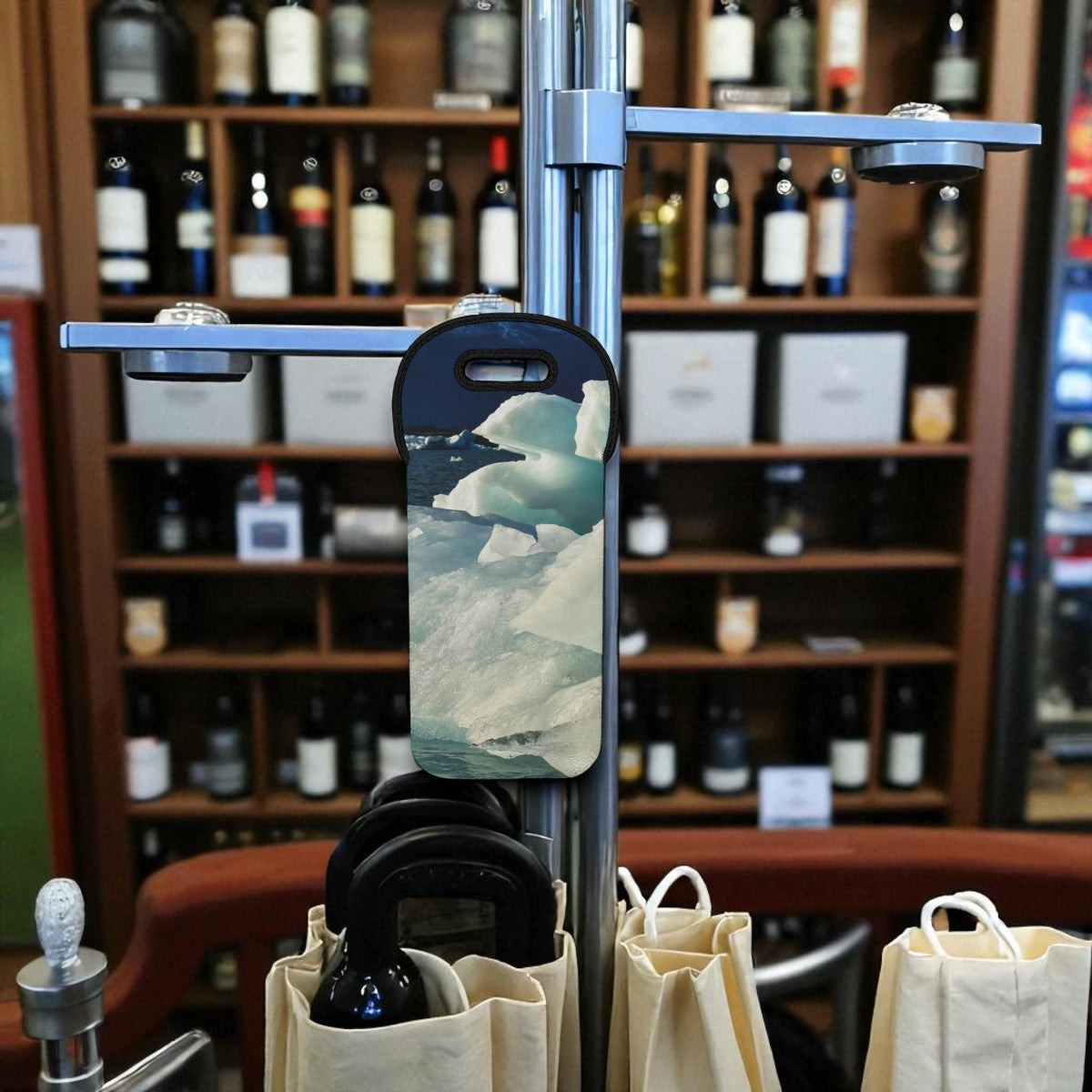 Phone case with a mountain design held by a stand in front of a wine rack.