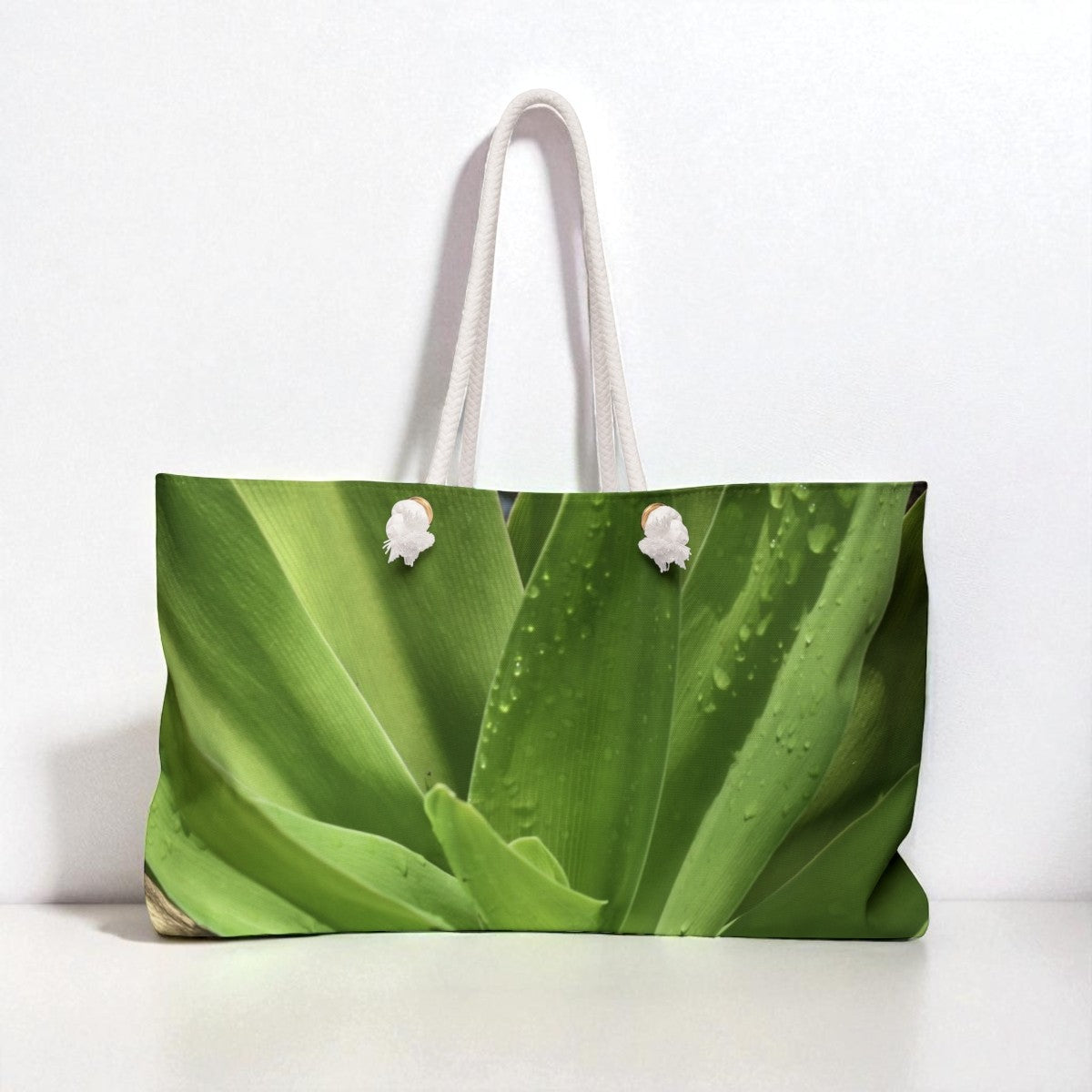 Tote bag with a green leaf pattern on a white background
