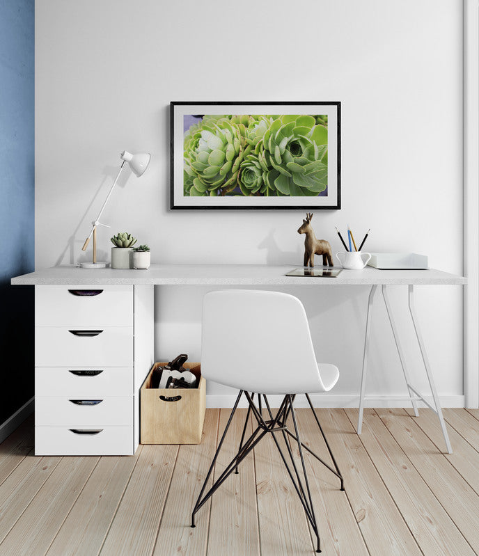 Modern home office with white desk, chair, and decor elements.