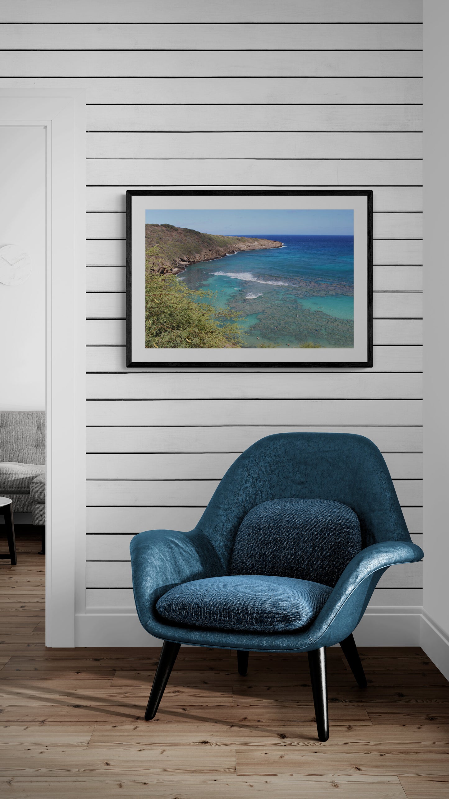 Blue armchair in a room with a framed picture of a beach on the wall. Hanauma Bay Surf Original Photograph by Kim A. Bailey