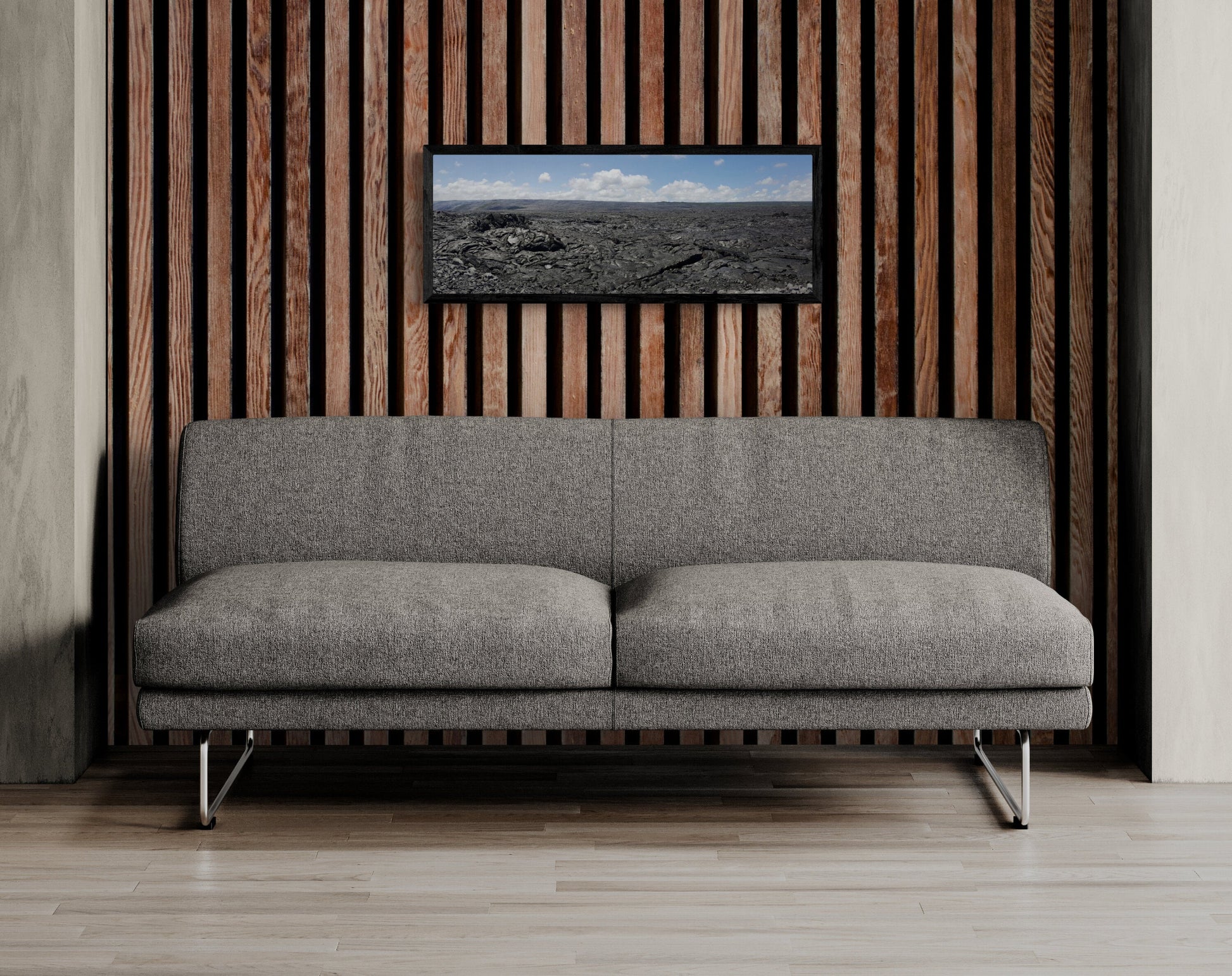 Gray sofa in a room with a wooden wall panel and a picture of a landscape. Kilauea Lava Field Panoramic, Original Photograph by Kim A. Bailey