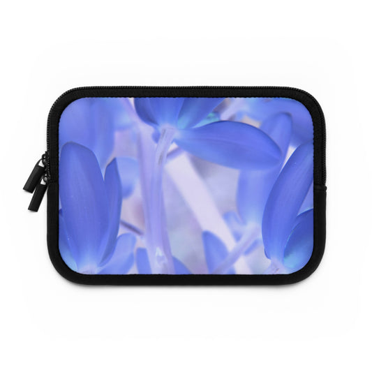 A neoprene laptop or tablet sleeve with a black back and a blue floral design front, featuring dual zipper enclosures.