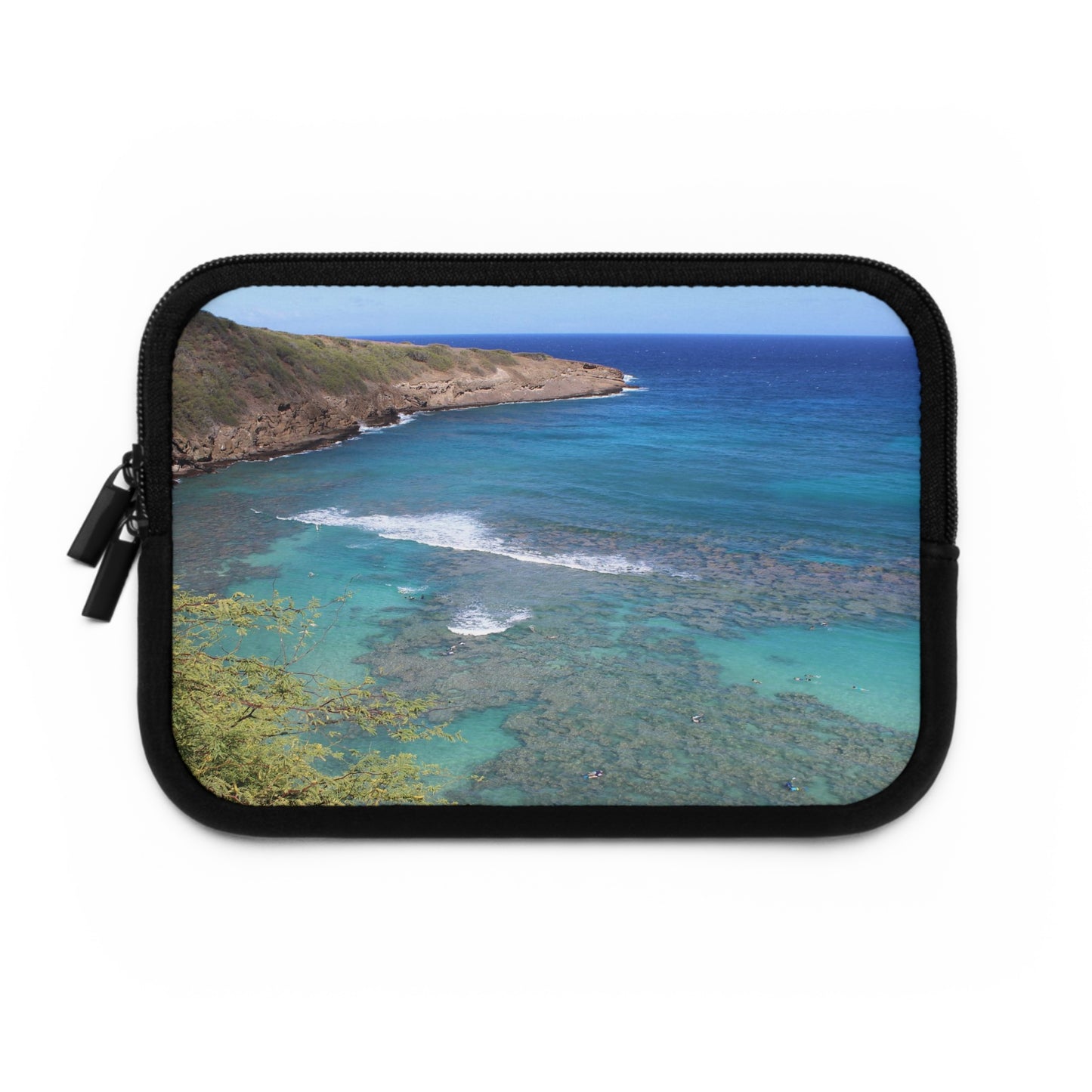 A neoprene laptop or tablet sleeve with a black back and a beach scene photograph printed on the front.